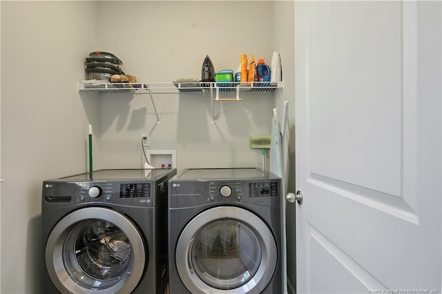 laundry area with washing machine and clothes dryer and laundry area