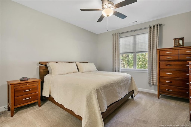 bedroom featuring a ceiling fan, visible vents, light colored carpet, and baseboards