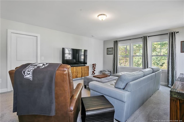 carpeted living room featuring baseboards