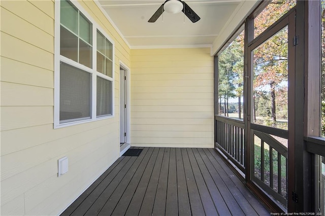 unfurnished sunroom with ceiling fan