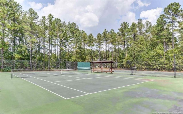 view of sport court featuring fence
