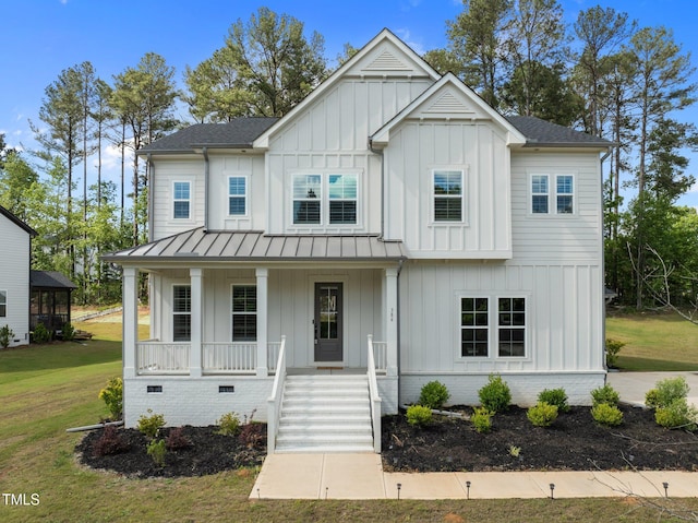 386 The Parks Dr, Pittsboro, NC 27312 - modern farmhouse with board and batten siding, covered porch, a standing seam roof, and a front yard