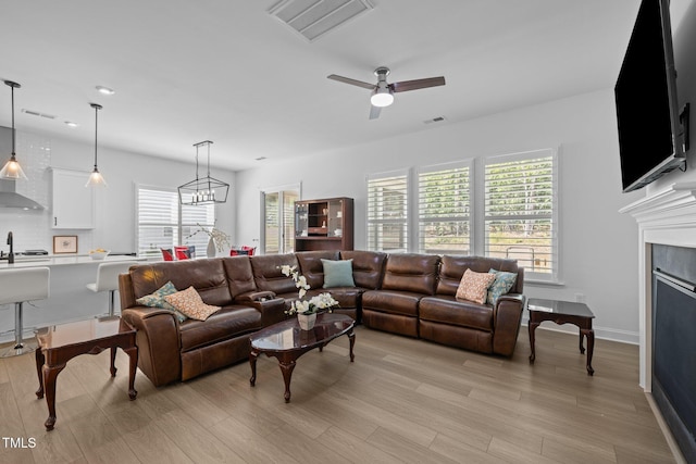 386 The Parks Dr, Pittsboro, NC 27312 - living room with healthy amount of natural light, a ceiling fan, and light wood finished floors