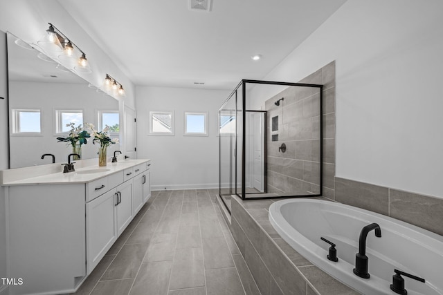 386 The Parks Dr, Pittsboro, NC 27312 - full bathroom featuring a stall shower, a garden tub, double vanity, and healthy amount of natural light
