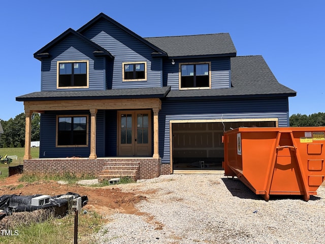 240 Noramac Ct, Selma, NC 27576 - view of front of home featuring covered porch, a garage, gravel driveway, and roof with shingles