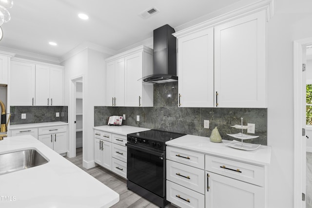 kitchen with visible vents, decorative backsplash, black electric range oven, wall chimney range hood, and light countertops