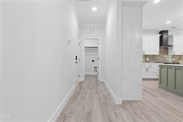 hallway featuring crown molding, recessed lighting, light wood-type flooring, and visible vents