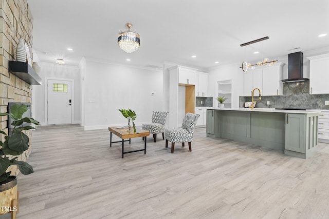 living room with crown molding, recessed lighting, a chandelier, and light wood-style floors