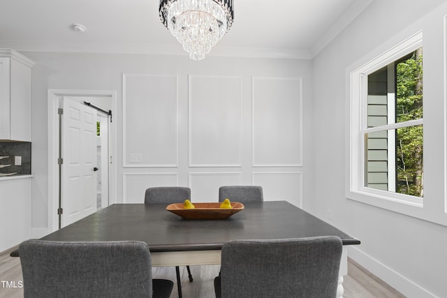 dining area featuring a notable chandelier, plenty of natural light, and light wood-style flooring