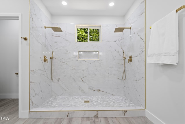 full bath with a marble finish shower, baseboards, recessed lighting, and wood finished floors