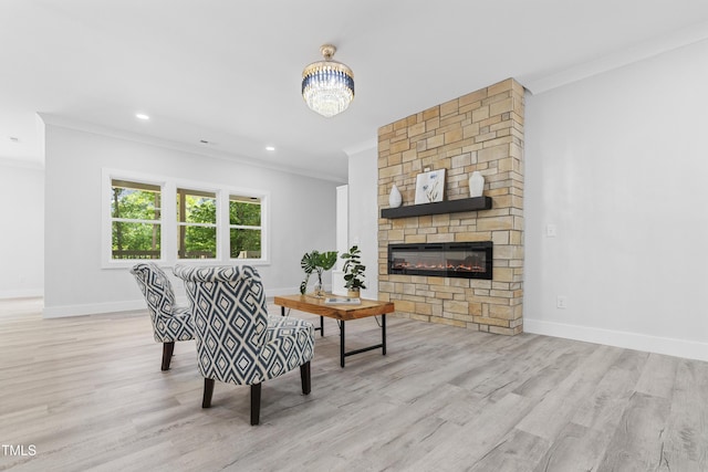 living room featuring crown molding, baseboards, a large fireplace, and wood finished floors