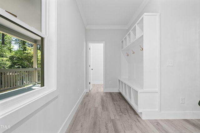 mudroom with crown molding, light wood-style flooring, and baseboards