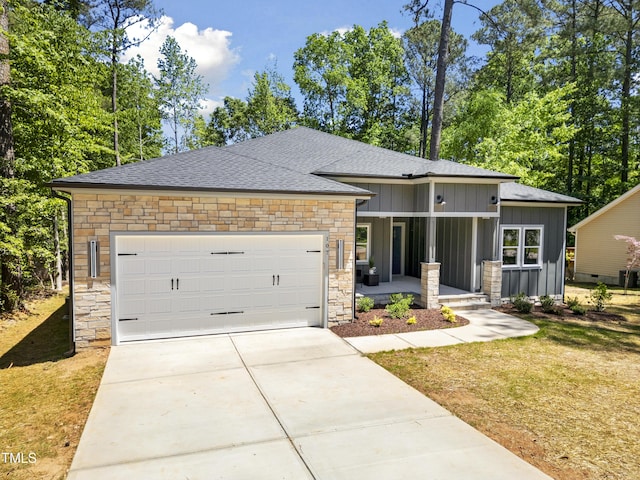 view of front of property featuring stone siding, a garage, board and batten siding, a porch, and driveway