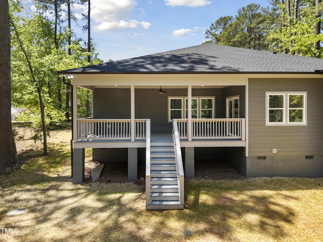 rear view of property with stairway, roof with shingles, and crawl space