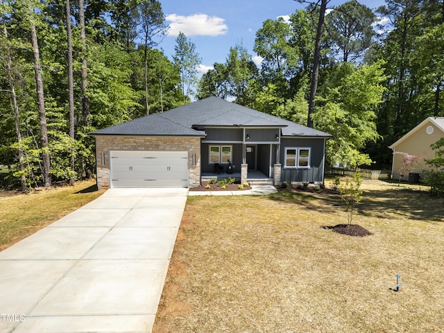 view of front of house with a garage, roof with shingles, board and batten siding, a porch, and driveway