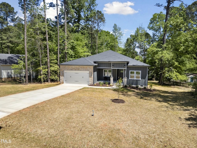 view of front facade with fence, a shingled roof, an attached garage, board and batten siding, and driveway