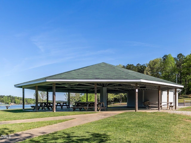 view of community featuring a lawn, a water view, and a gazebo