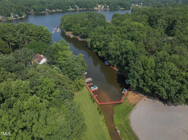 aerial view featuring a water view and a wooded view