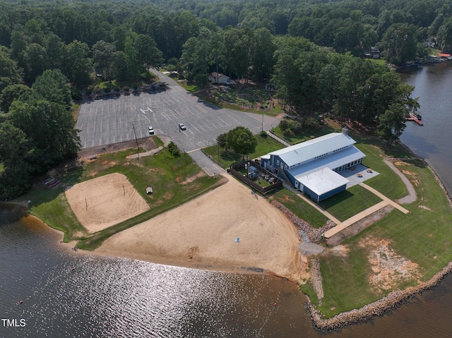 aerial view with a water view and a wooded view