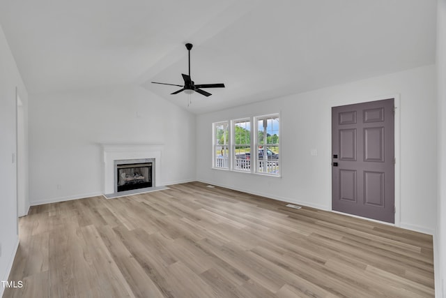 112 Edmondson Dr, Willow Springs, NC 27592 - unfurnished living room featuring light wood-type flooring, a ceiling fan, vaulted ceiling, and a high end fireplace