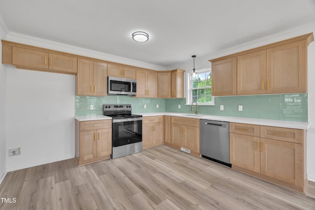 112 Edmondson Dr, Willow Springs, NC 27592 - kitchen featuring light brown cabinetry, stainless steel appliances, light countertops, a sink, and light wood-style floors