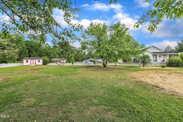 112 Edmondson Dr, Willow Springs, NC 27592 - view of yard with a storage unit, a fenced backyard, and an outbuilding