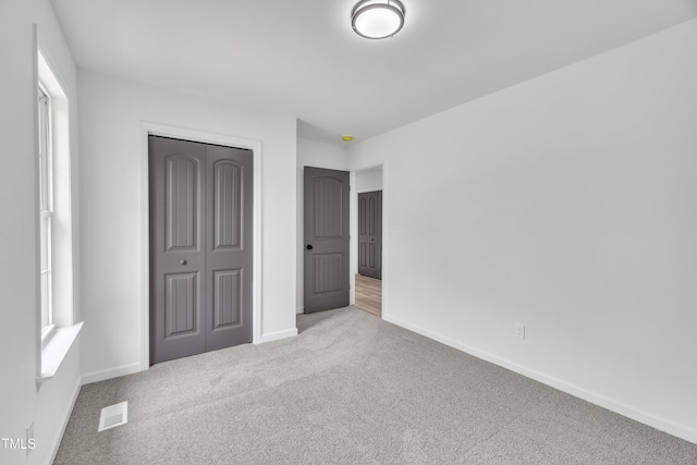 112 Edmondson Dr, Willow Springs, NC 27592 - unfurnished bedroom featuring a closet, carpet flooring, visible vents, and baseboards