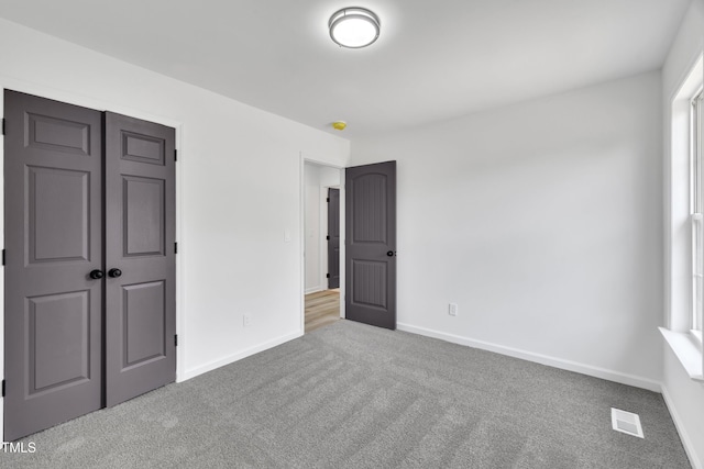 112 Edmondson Dr, Willow Springs, NC 27592 - unfurnished bedroom featuring a closet, visible vents, carpet floors, and baseboards