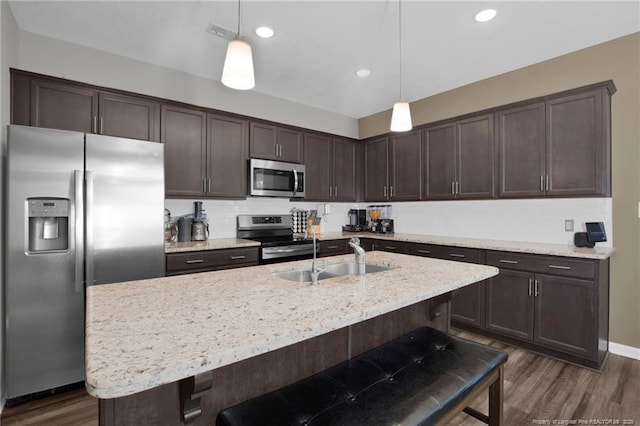 504 Loom Dr, Fayetteville, NC 28306 - kitchen with appliances with stainless steel finishes, dark brown cabinets, a sink, dark wood-type flooring, and recessed lighting