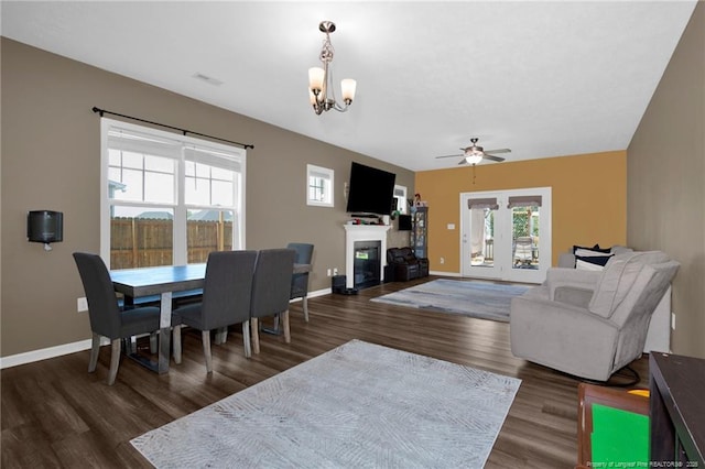 504 Loom Dr, Fayetteville, NC 28306 - dining space featuring a chandelier, a glass covered fireplace, a ceiling fan, wood finished floors, and baseboards