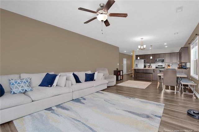 504 Loom Dr, Fayetteville, NC 28306 - living room with a chandelier, a ceiling fan, wood finished floors, baseboards, and recessed lighting