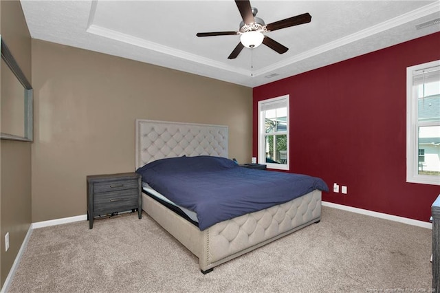 504 Loom Dr, Fayetteville, NC 28306 - carpeted bedroom featuring multiple windows, baseboards, a tray ceiling, and crown molding