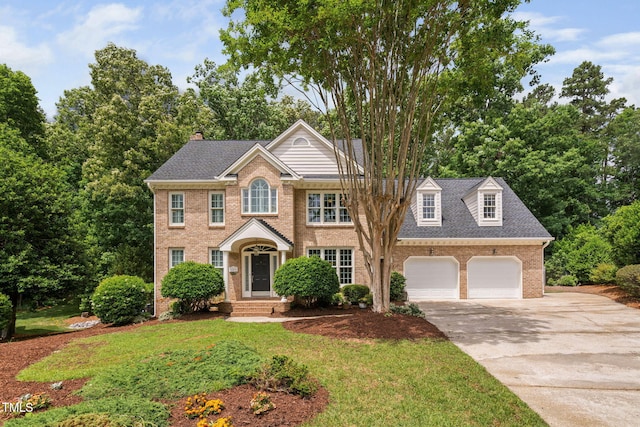 108 Nimbus Ct, Cary, NC 27513 - view of front of house featuring brick siding, concrete driveway, a garage, roof with shingles, and a chimney