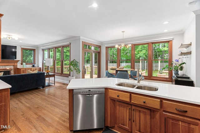 108 Nimbus Ct, Cary, NC 27513 - kitchen featuring stainless steel dishwasher, a sink, light countertops, ornamental molding, and light wood-style flooring