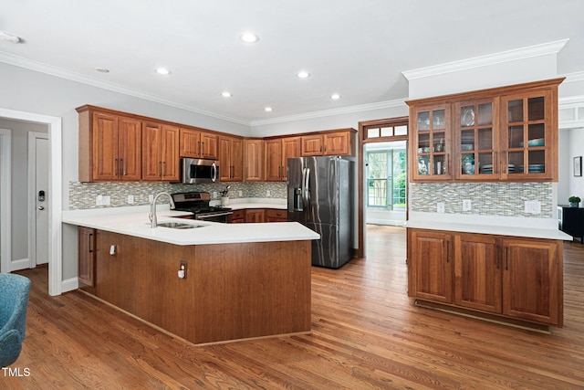 108 Nimbus Ct, Cary, NC 27513 - kitchen with stainless steel appliances, a sink, a peninsula, backsplash, and wood finished floors