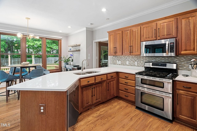 108 Nimbus Ct, Cary, NC 27513 - kitchen featuring stainless steel appliances, a sink, a peninsula, light countertops, and ornamental molding
