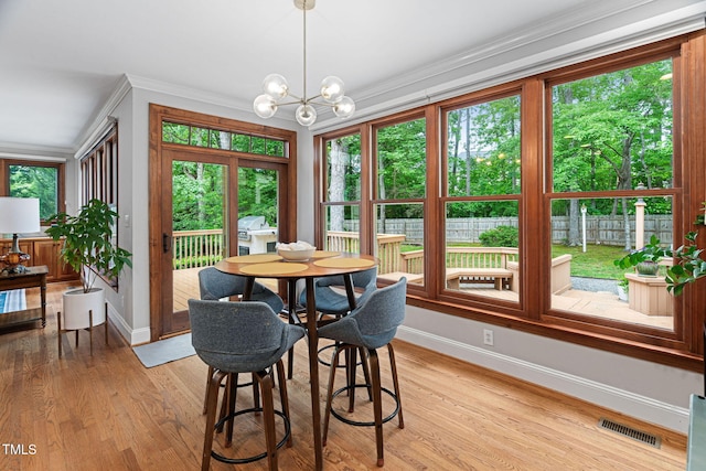 108 Nimbus Ct, Cary, NC 27513 - dining space with baseboards, plenty of natural light, light wood-style flooring, and crown molding