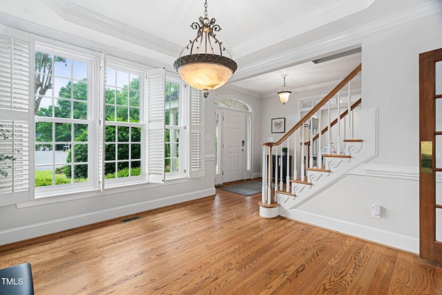 108 Nimbus Ct, Cary, NC 27513 - entryway with healthy amount of natural light, wood finished floors, baseboards, ornamental molding, and stairway