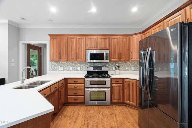 108 Nimbus Ct, Cary, NC 27513 - kitchen featuring stainless steel appliances, a sink, ornamental molding, light countertops, and brown cabinets