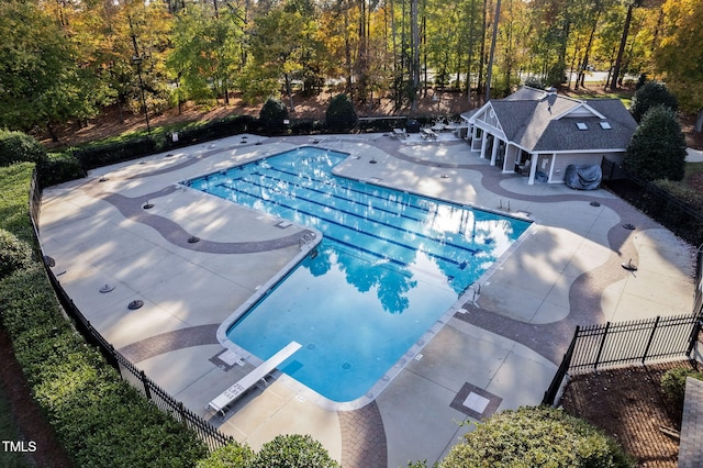 108 Nimbus Ct, Cary, NC 27513 - community pool with a patio, a diving board, fence, an outbuilding, and a storage structure