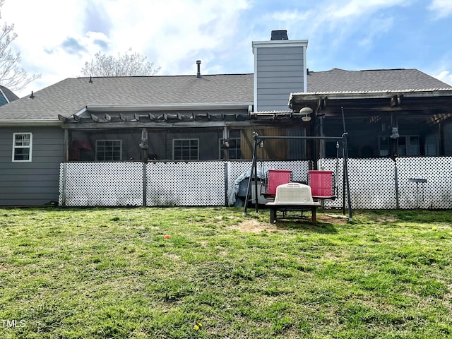 rear view of house with a chimney, a yard, a pergola, and a shingled roof
