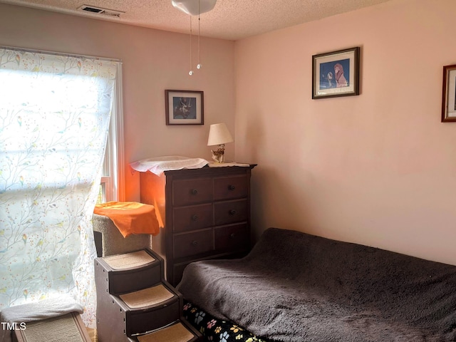 bedroom with visible vents and a textured ceiling