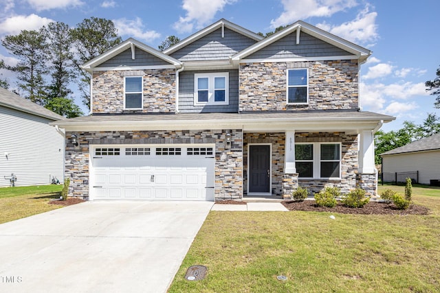 craftsman inspired home with stone siding, a front yard, concrete driveway, and an attached garage
