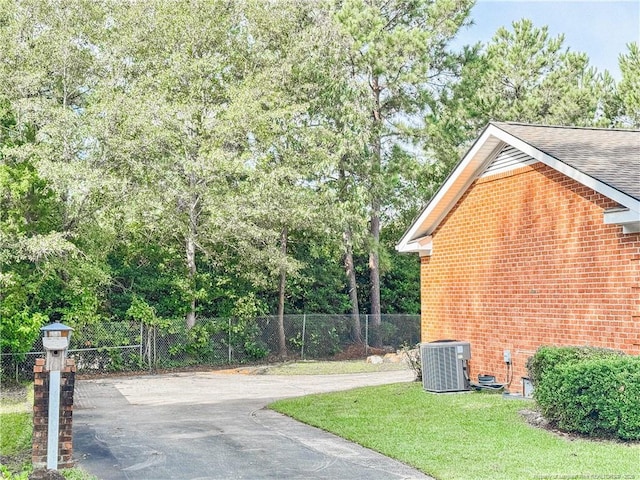 332 Rainier Dr, Fayetteville, NC 28314 - view of property exterior with a lawn, brick siding, fence, and cooling unit