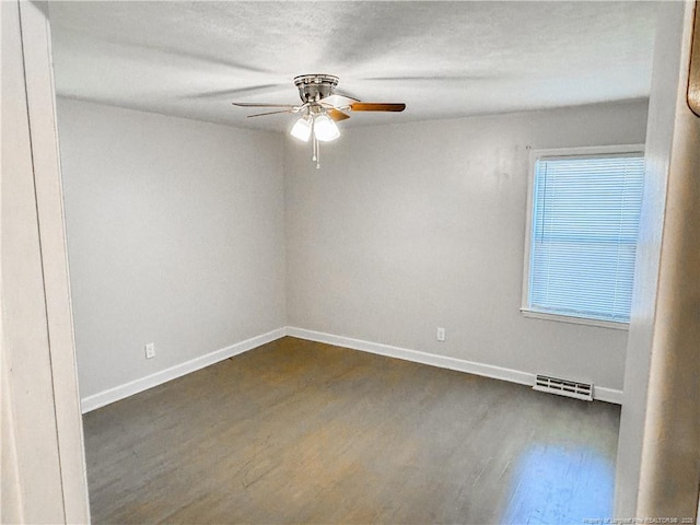 332 Rainier Dr, Fayetteville, NC 28314 - unfurnished room with baseboards, a ceiling fan, dark wood-type flooring, and visible vents