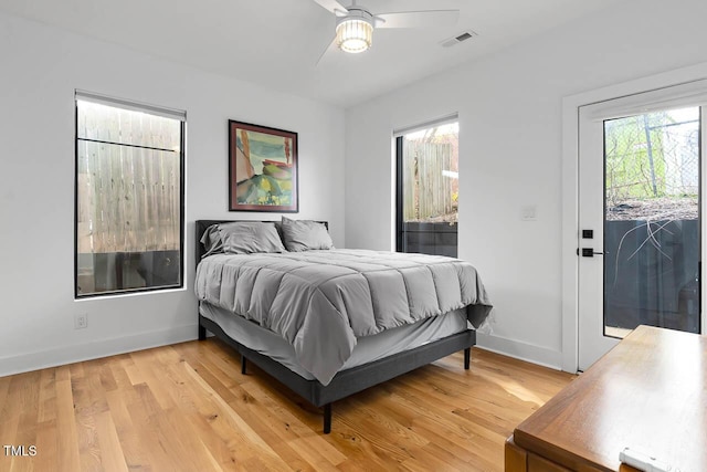 211 W Coporation, Durham, NC 27701 - bedroom with baseboards, light wood finished floors, access to exterior, and a ceiling fan