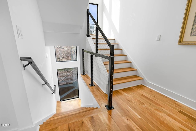 211 W Coporation, Durham, NC 27701 - stairway featuring wood finished floors, baseboards, and a high ceiling