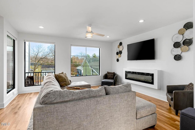 211 W Coporation, Durham, NC 27701 - living area featuring light wood-style floors, ceiling fan, a glass covered fireplace, recessed lighting, and baseboards