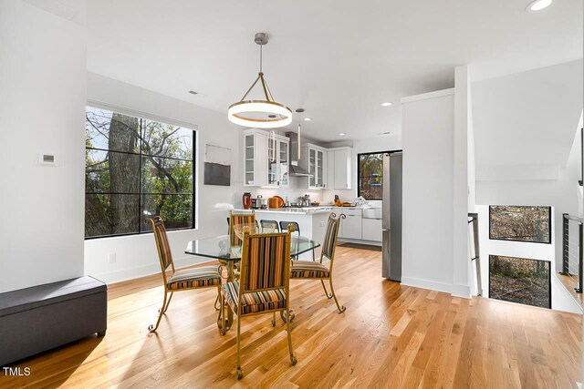 211 W Coporation, Durham, NC 27701 - dining room featuring plenty of natural light, light wood finished floors, recessed lighting, and baseboards