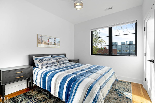 211 W Coporation, Durham, NC 27701 - bedroom featuring wood finished floors and baseboards